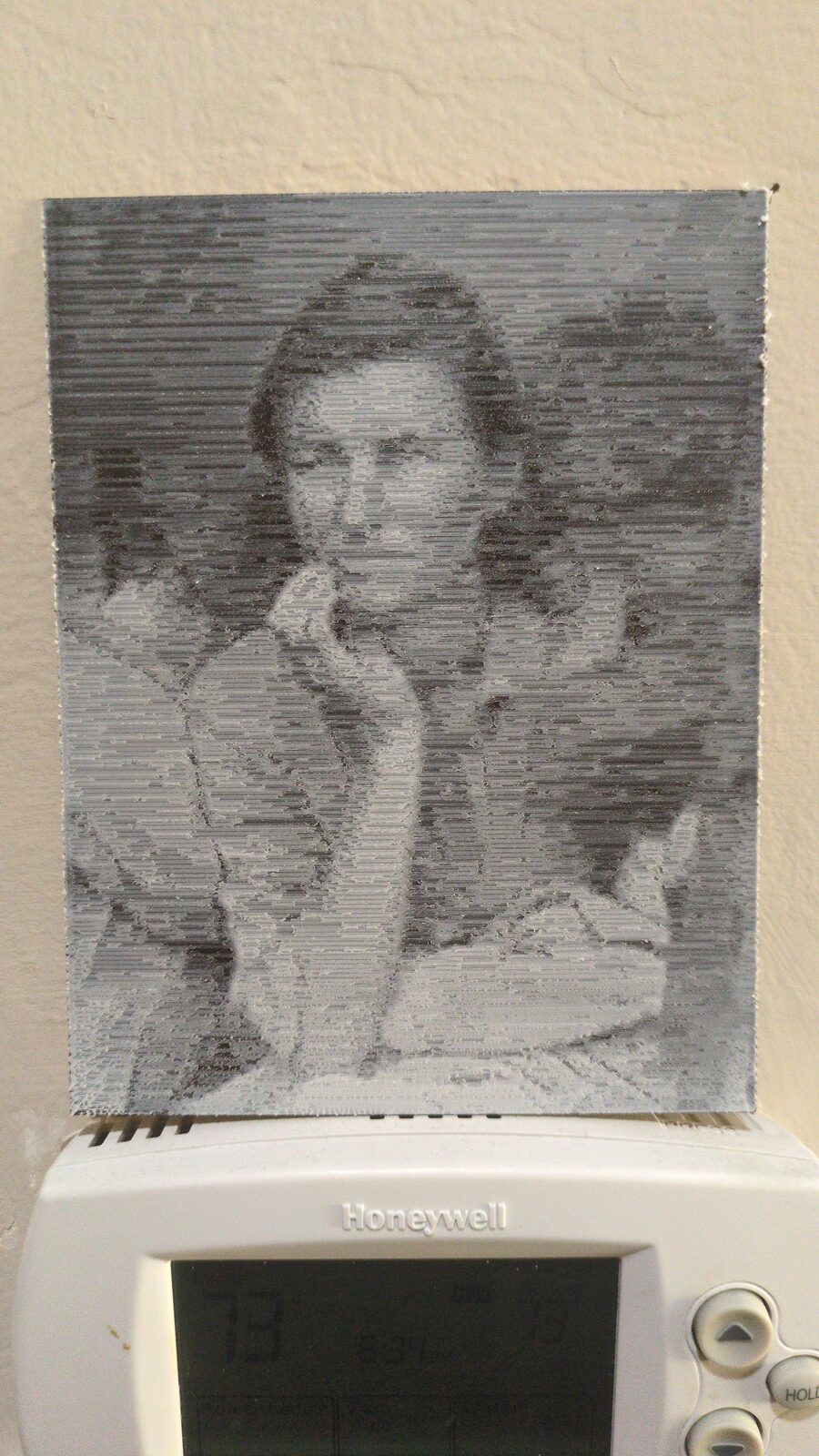 The printed Migrant Mother hanging on a wall